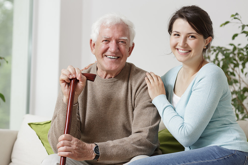 Care worker with senior man smiling
