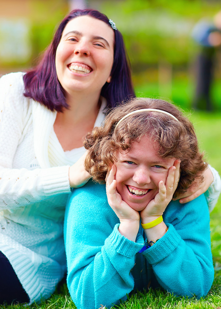 Two women with disabilities smiling
